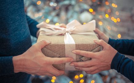 Two people exchanging a christmas gift