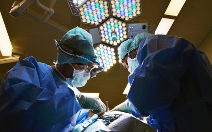 Doctors performing surgery in theatre