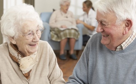 Elderly couple smiling in care home